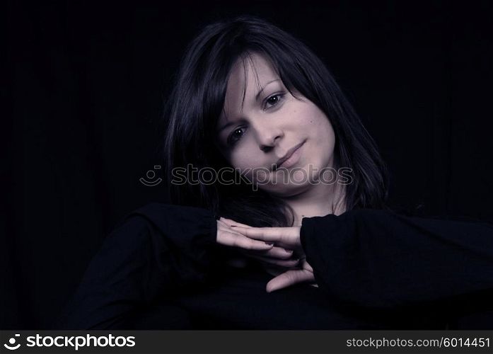 Young woman posing in black background in casual clothes
