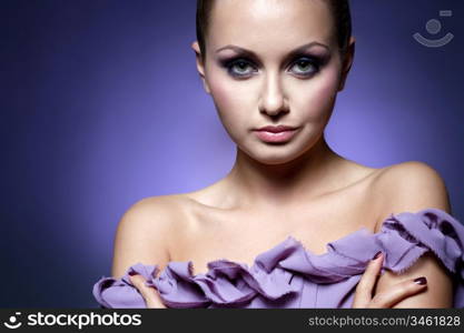 young woman posing in purple dress, studio shot