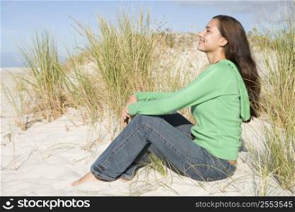 Young woman posing on a sand hill
