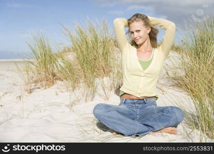 Young woman posing on a sand hill