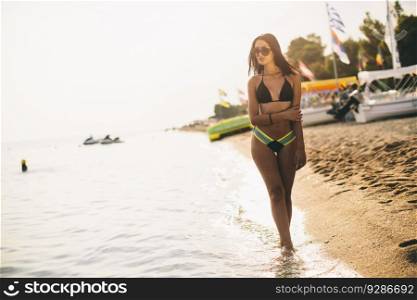 Young woman posing on the beach in a bikini