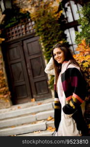 Young woman posing outside in autumn day