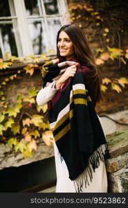 Young woman posing outside in autumn day