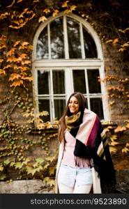 Young woman posing outside in autumn day