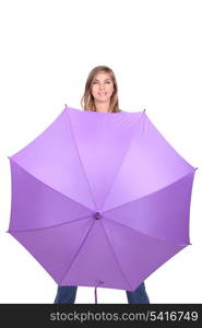 Young woman posing with an open umbrella in bright purple