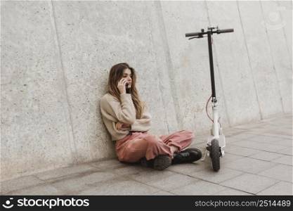 young woman posing with electric scooter 2