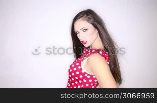 Young woman posing with her red polka dots dress