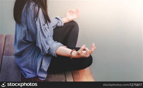 Young Woman Practices Yoga in Outdoor. Sitting in Lotus Position. Unplugged Life and Mental Health Concept. Sukhasana Posture and Meditating