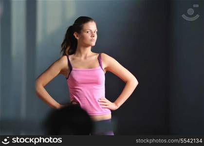 young woman practicing fitness and working out in a gym
