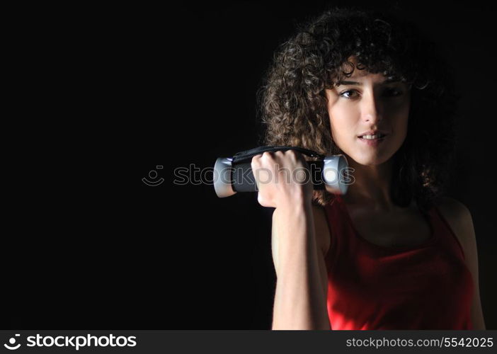 young woman practicing fitness and working out in a gym with dumbbell, weight lifting concept.