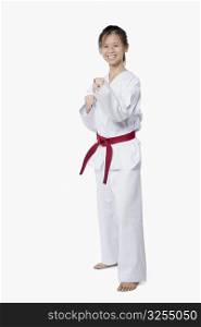 Young woman practicing karate and smiling