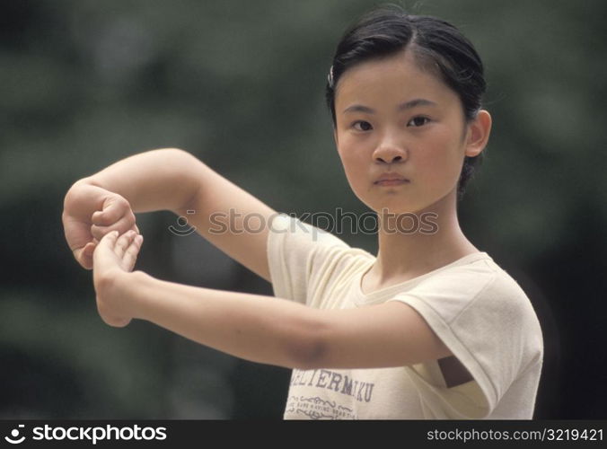 Young Woman Practicing Tai Chi