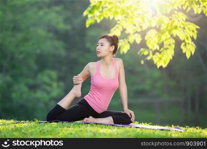 young woman practicing yoga in park outdoor, Meditation.