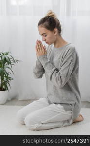 young woman praying home