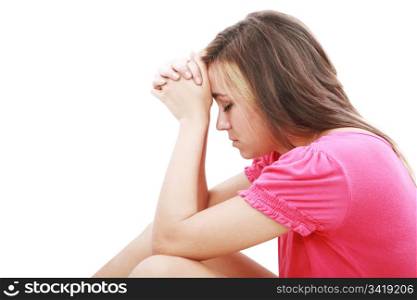 Young woman praying sincerely with her hands folded and eyes closed