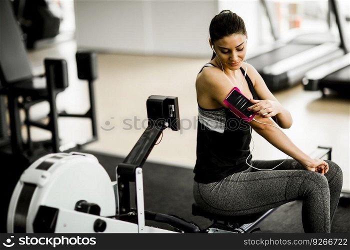Young woman preparing for workout at the gym