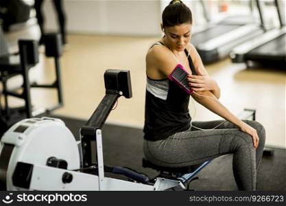Young woman preparing for workout at the gym