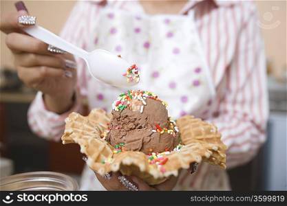 Young woman preparing ice cream
