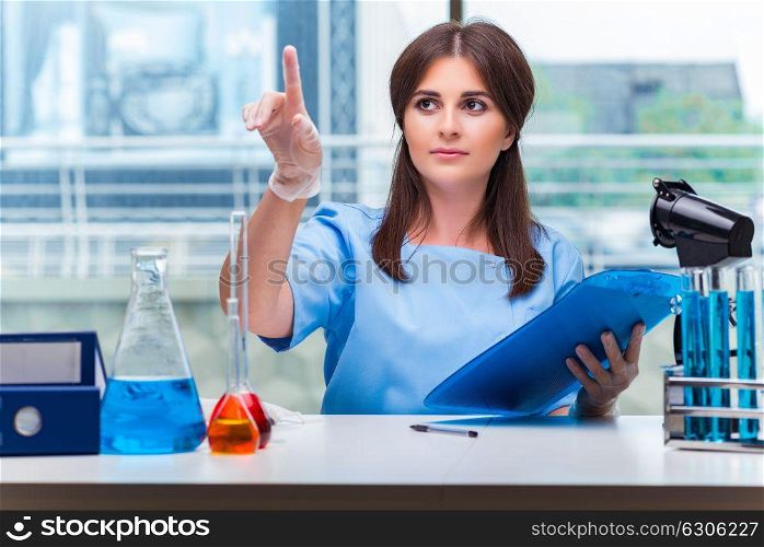 Young woman pressing buttons in lab