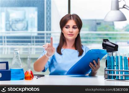 Young woman pressing buttons in lab