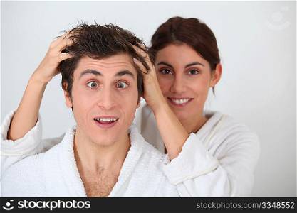 Young woman putting her hands in her boyfriend&acute;s hair