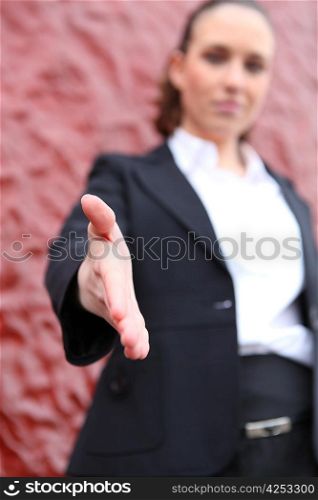 Young woman reaching out the hand for handshaking