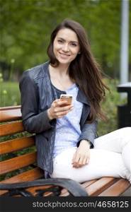 Young woman reading a message on the phone