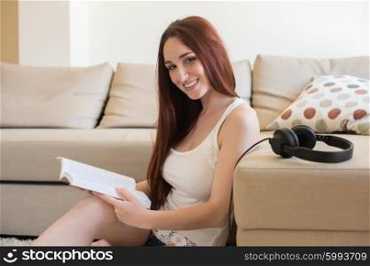 Young woman reading book on the couch