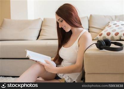 Young woman reading book on the couch