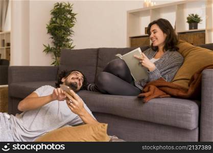 young woman reading living room her husband
