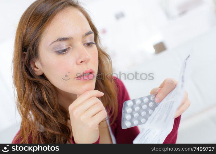 young woman reading medication prescription