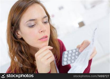 young woman reading medication prescription
