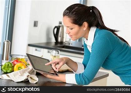 Young woman reading recipe tablet searching kitchen preparing vegetables
