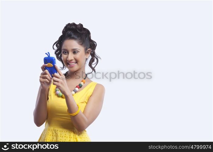 Young woman reading sms on mobile phone