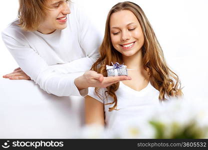 Young woman receiving a gift from her boyfriend