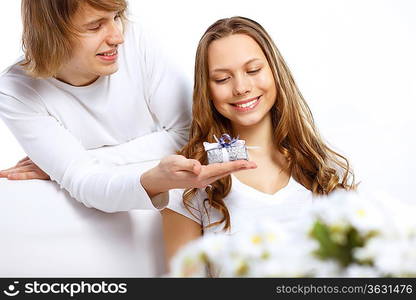 Young woman receiving a gift from her boyfriend