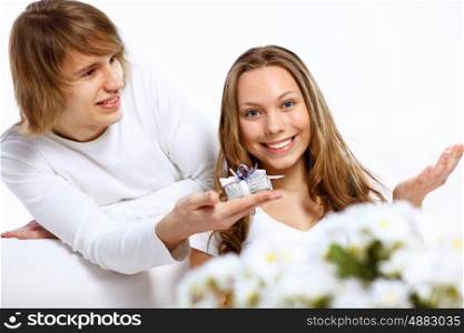 Young woman receiving a gift from her boyfriend