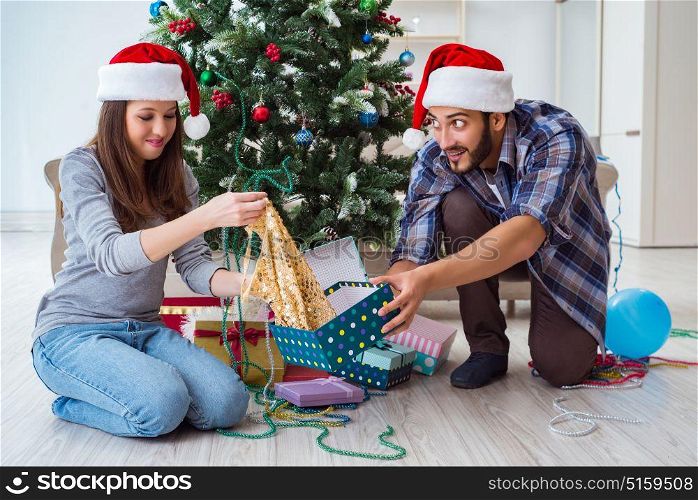 Young woman receiving dress as christmas gift