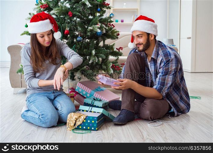 Young woman receiving gold watch as christmas gift. The young woman receiving gold watch as christmas gift