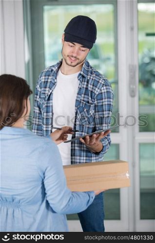 young woman receiving parcel from delivery man