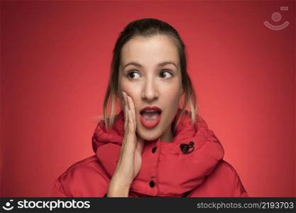 young woman red winter coat shouting sign