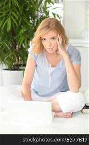 Young woman relaxed using laptop at home