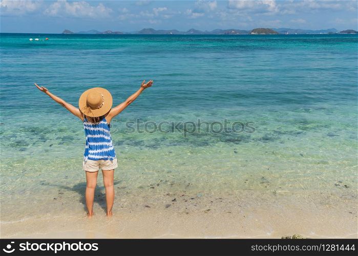 Young woman relaxing and enjoying at the tropical beach, Summer vacation and travel concept