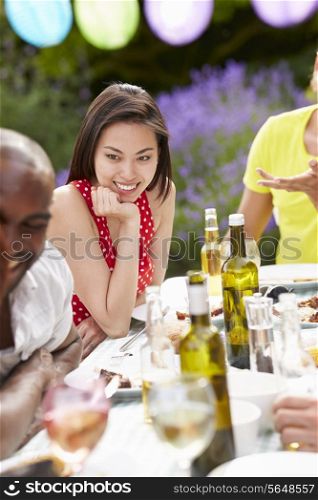 Young Woman Relaxing At Outdoor Barbeque