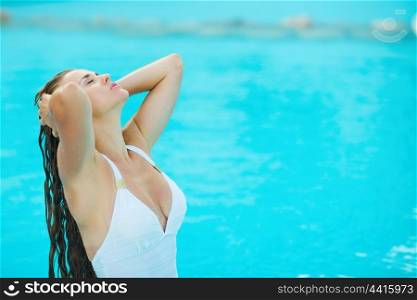 Young woman relaxing at poolside