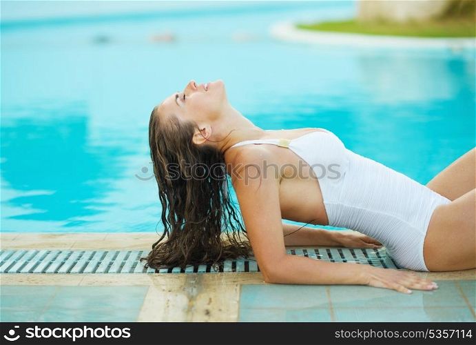 Young woman relaxing in poolside