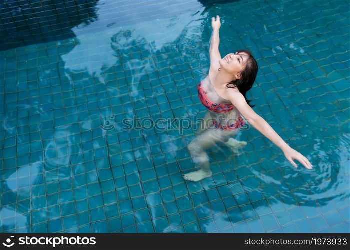 young woman relaxing in swimming pool