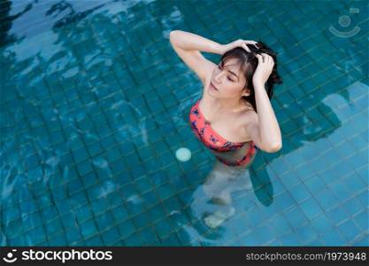young woman relaxing in swimming pool