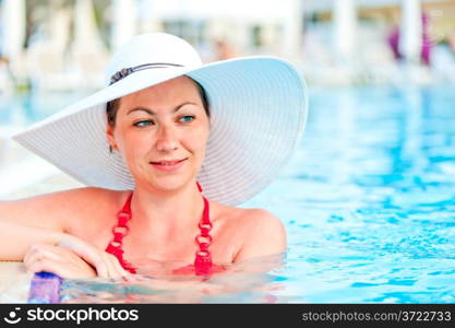 young woman relaxing in the pool at the resort