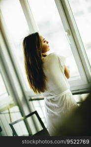 Young woman relaxing in the room after waking up